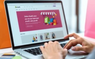 Laptop with Shopify interface and shopping bags nearby.